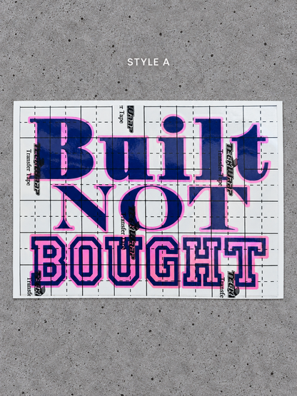 Style A Built Not Bought vinyl decal with Royal Pink outline and Glossy Blue lettering on transfer tape