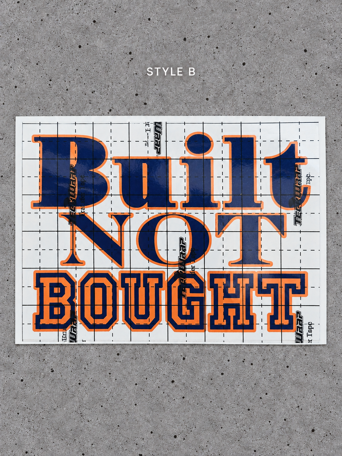 Style B Built Not Bought vinyl decal with Cayenne Orange outline and Glossy Blue lettering on transfer tape