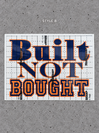 Style B Built Not Bought vinyl decal with Cayenne Orange outline and Glossy Blue lettering on transfer tape