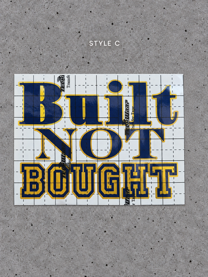 Style C Built Not Bought vinyl decal with Prime Gold outline and Glossy Blue lettering on transfer tape