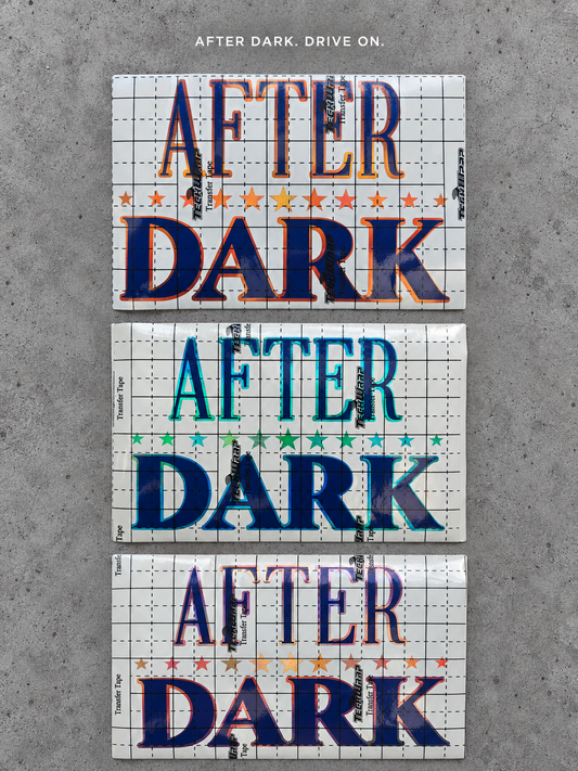 After Dark vinyl decal in three colours A, B and C under transfer tape on grey concrete