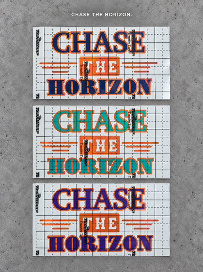 Chase the Horizon vinyl decal in blue, green and purple with orange outlines on grey concrete